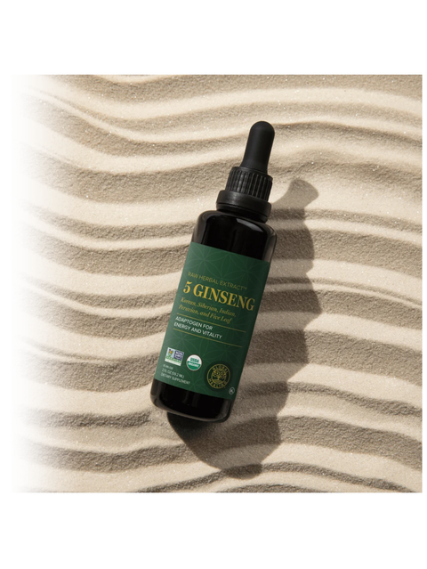 Bottle of 5 Ginseng tincture on a striped fabric background