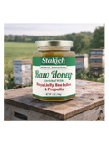Jar of Stakich Raw Honey with beekeeping equipment in the background