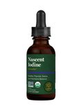 A bottle of Nascent Iodine Detoxadine dietary supplement. The product is in an amber glass dropper bottle with a black cap and a dark green label featuring white text and a purple accent line.