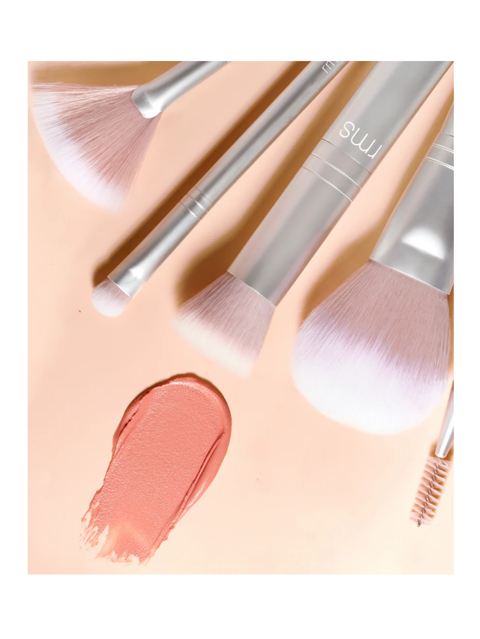 Blush Brush, RMS Beauty with pink bristles on a peach background