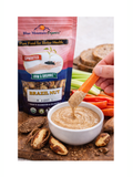 Blue Mountain Organics Brazil Nut product with a hand dipping a carrot into a bowl of dip.
