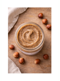 Jar Hazelnut Butter, Sprouted, 8oz, Blue Mountain Organics surrounded by hazelnuts on a wooden surface