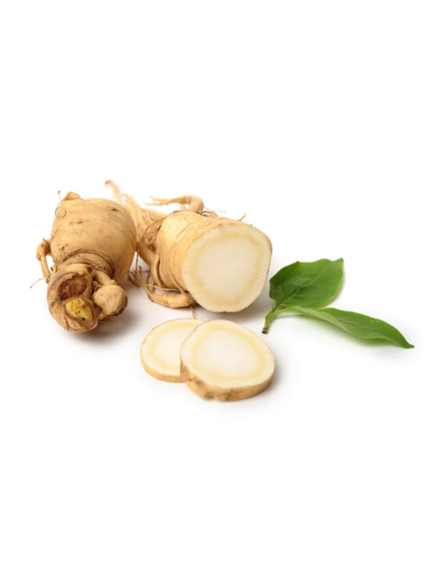 Ginseng root with slices and a leaf on a white background