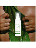 Organic Night Crème, 1oz, by Dr. Alkaitis with green leaf and hands in the background