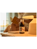 Bottle of Pomona juice on a table with a blurred background
