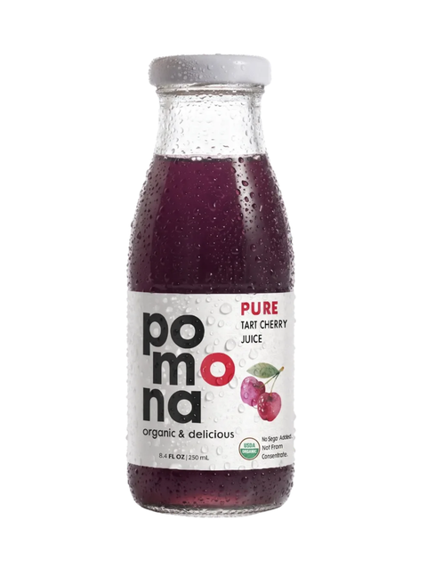 A bottle of Pomona Pure Tart Cherry Juice with condensation droplets, featuring a white label with red and black text and a gray cap, on a white background.