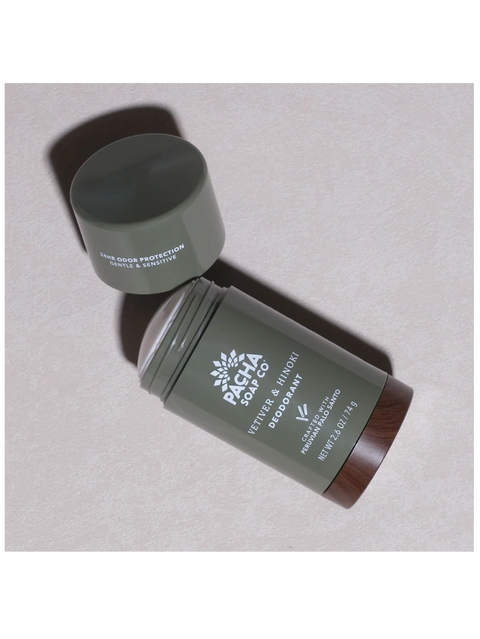 A stick deodorant and its cap from Pacha Soap Co. deodorant, shown on a textured light gray background.
