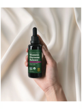 Hand holding a bottle labeled 'Women's Hormone Balance' against a soft beige background